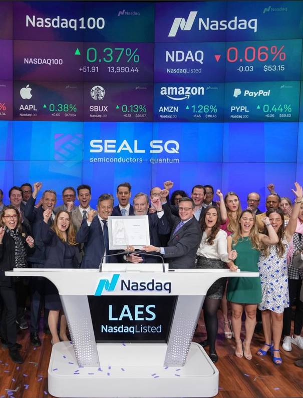 A group of people standing in front of a large screen

Description automatically generated